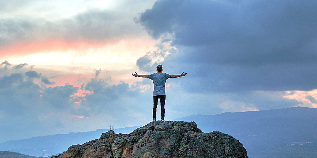 Man standing at pinnacle